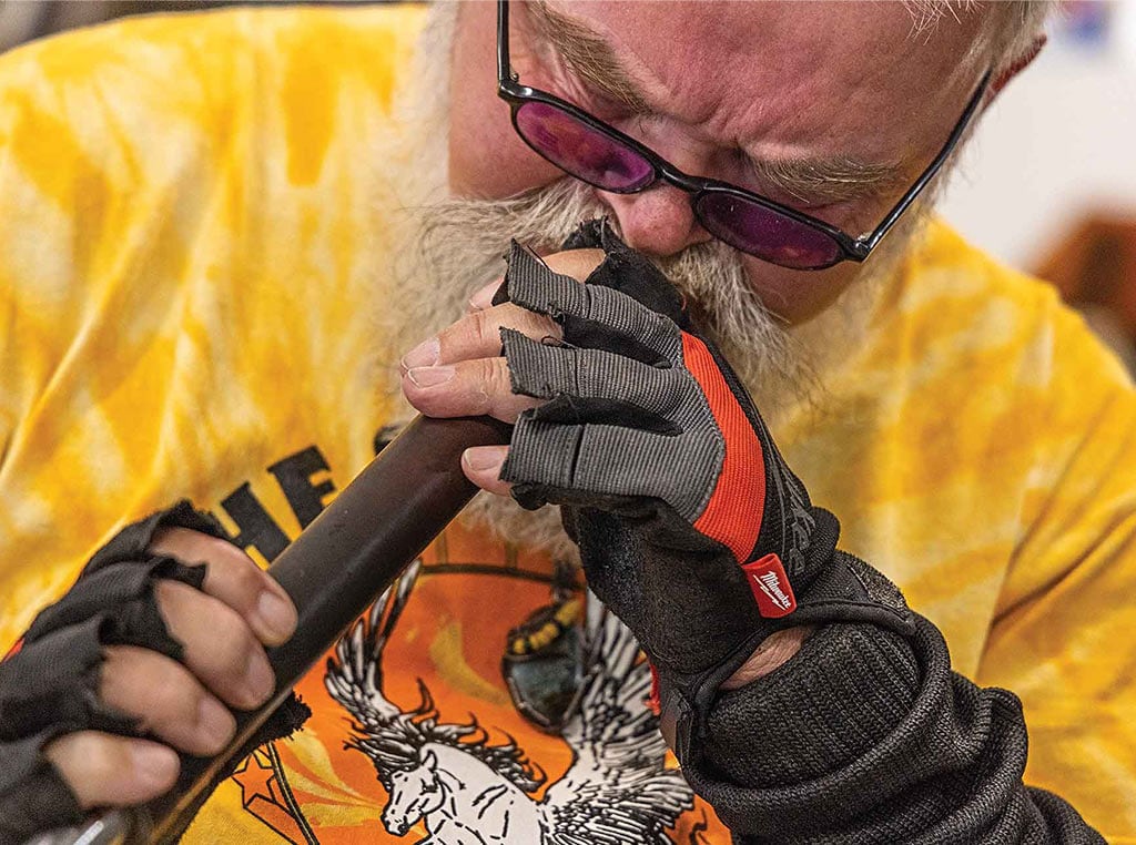 closeup of man blowing glass