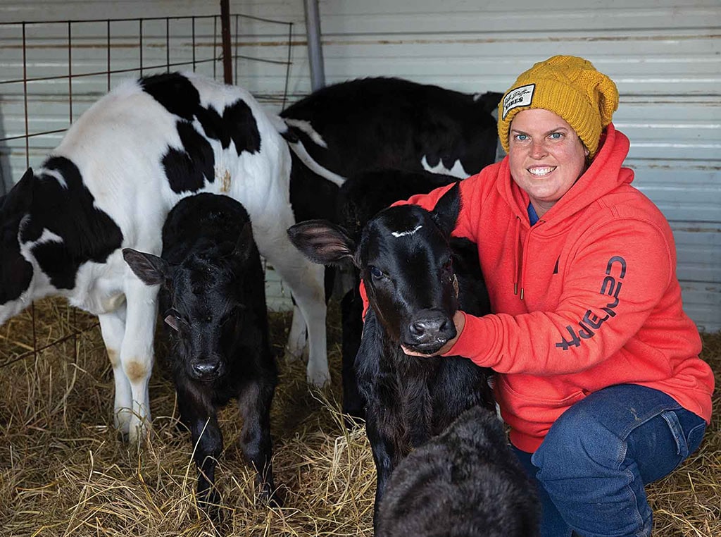 woman kneeling down holding calf