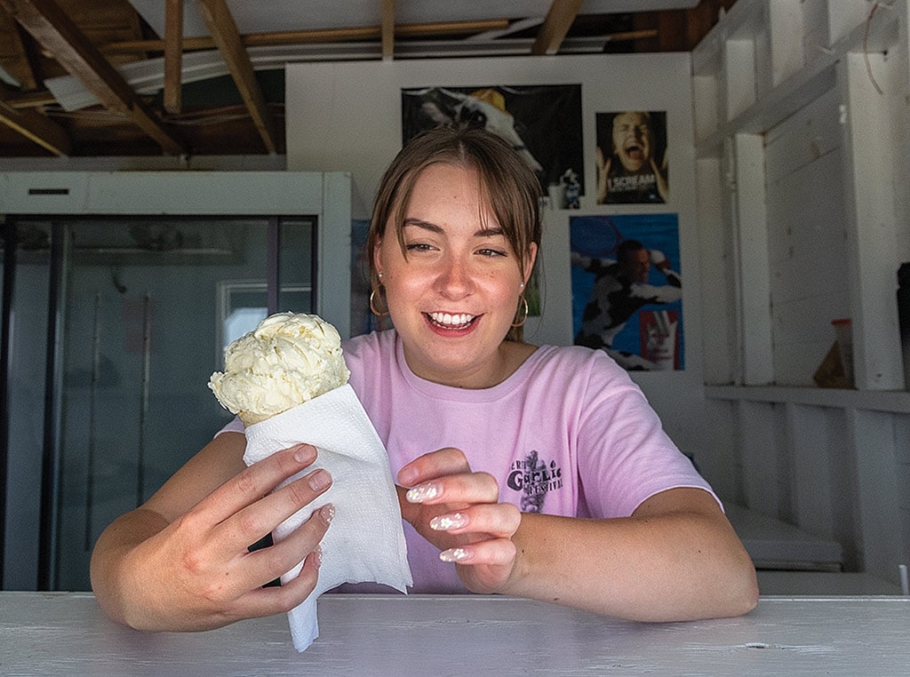 young woman holding garlic ice cream cone