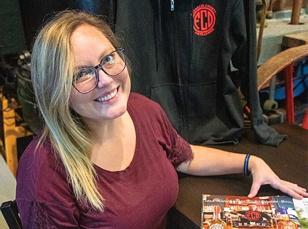 young woman with glasses smiling