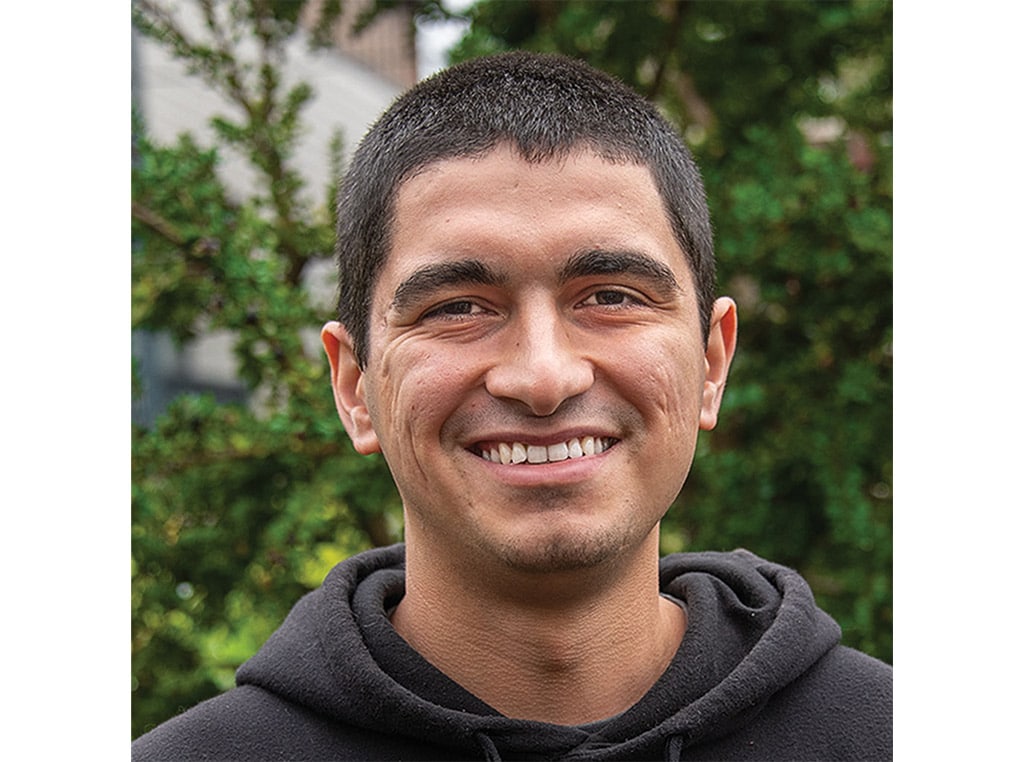 dark haired man with hoodie smiling