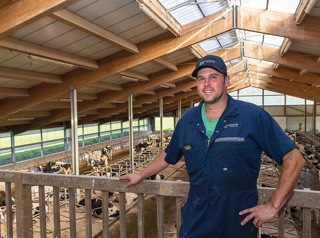 Eric Walker standing in front of cow pen