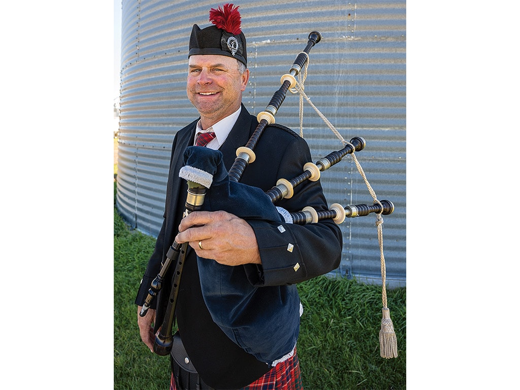 person wearing formal Scottish guard uniform with bagpipes