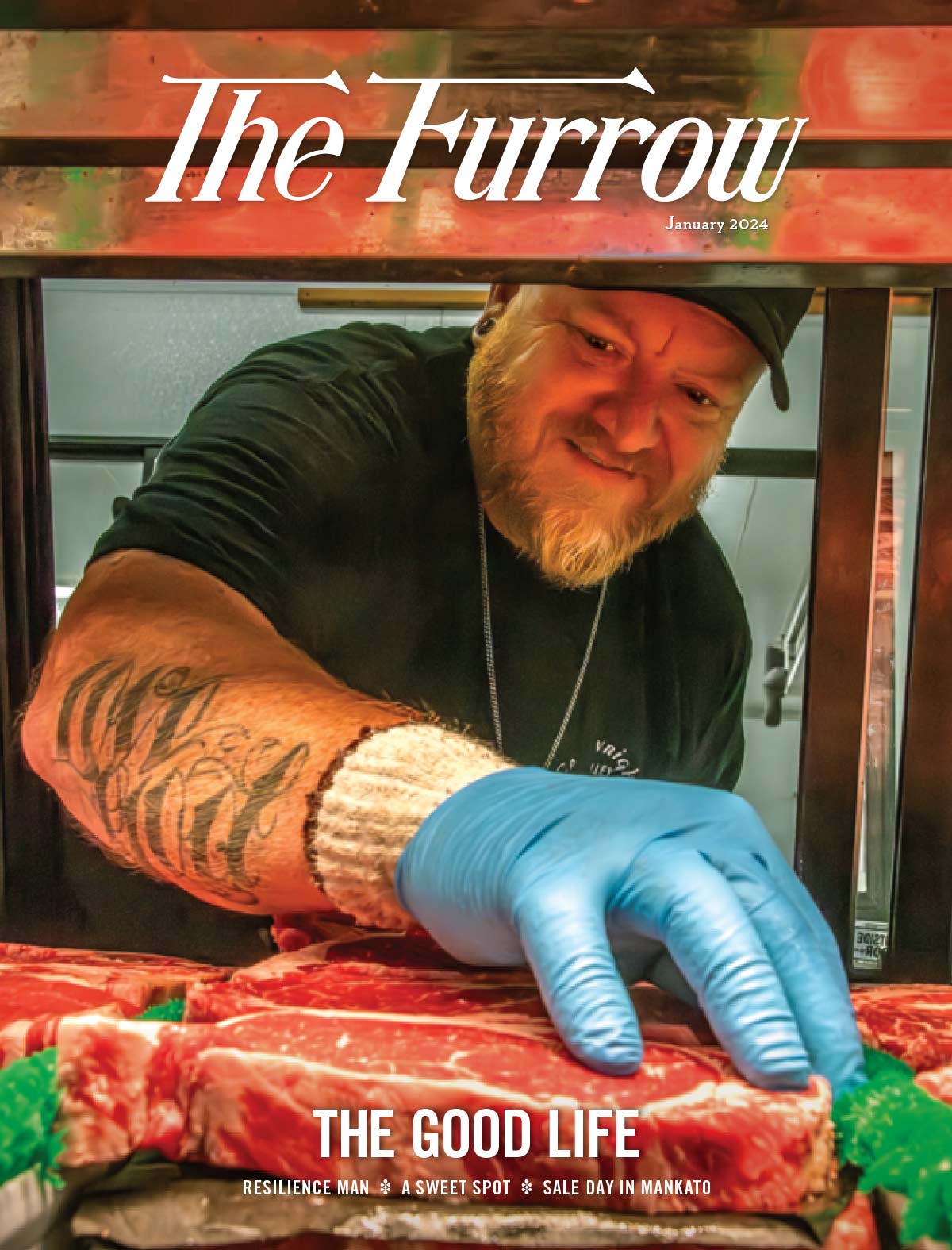 a chef with tattooed arm and light blue latex glove on inspecting a steak