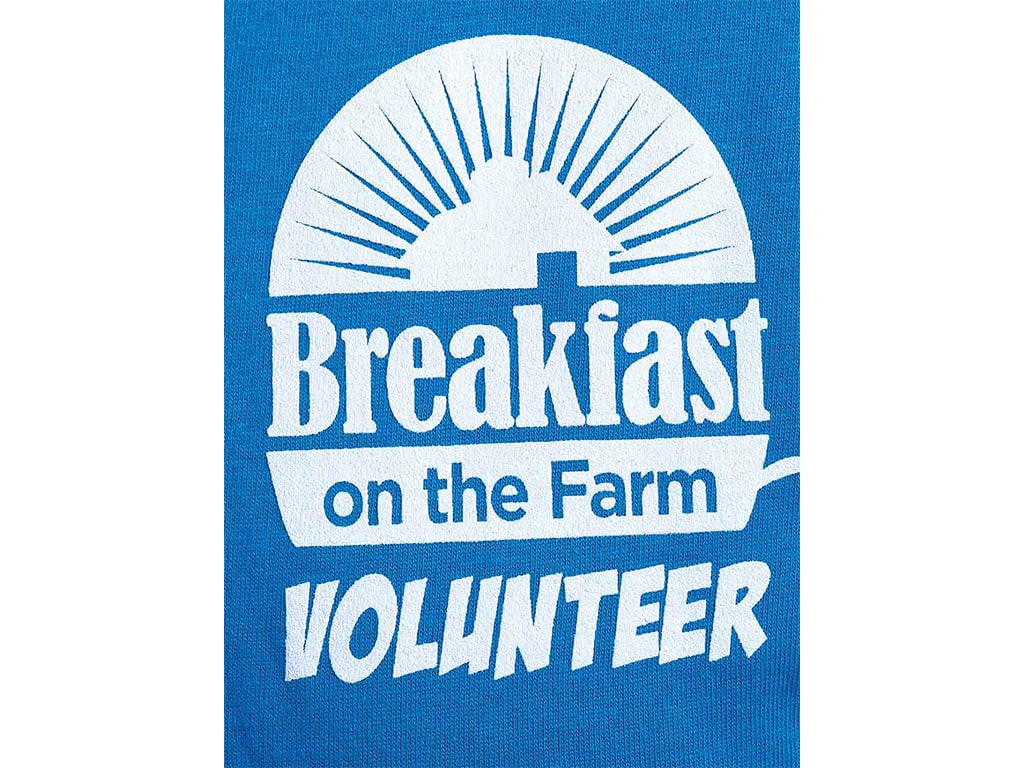 blue and white sign with breakfast on the farm volunteer printed on it
