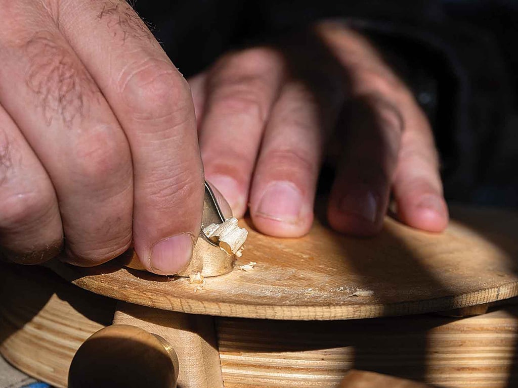 closeup of hands operating a finger plane