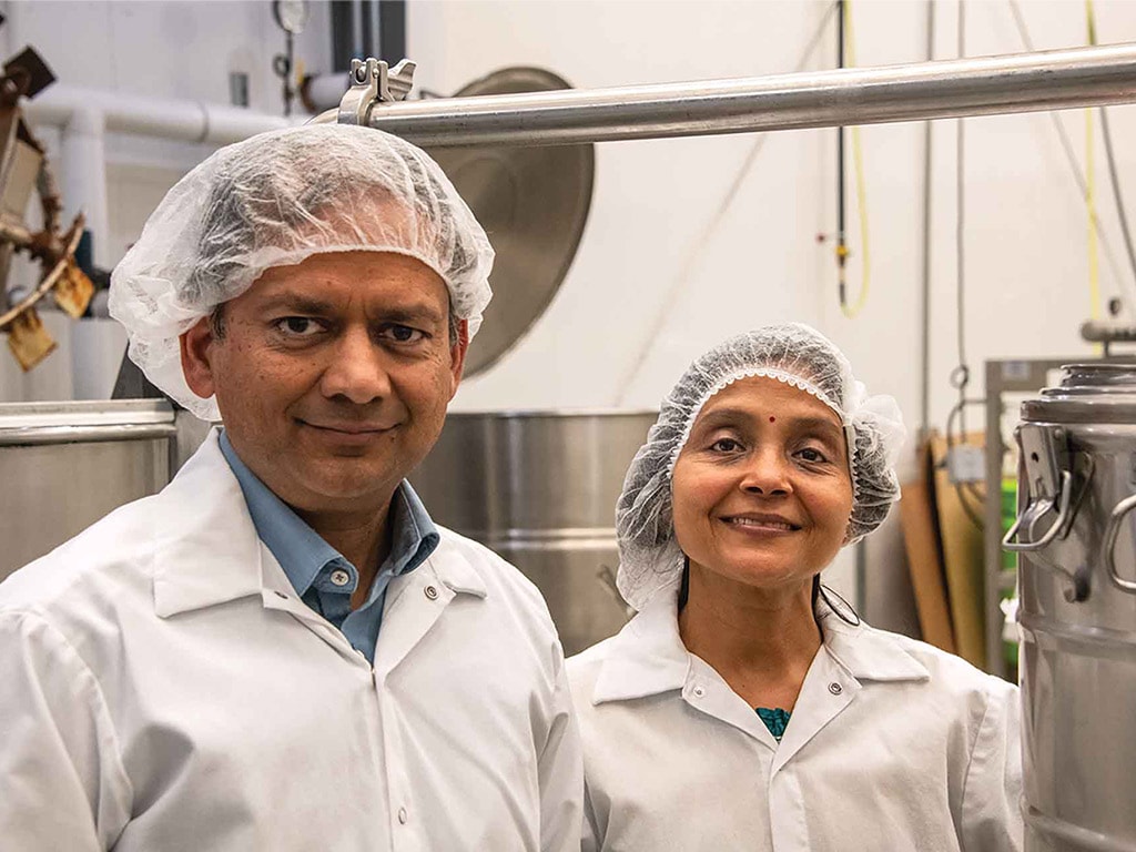 two smiling people in hair nets