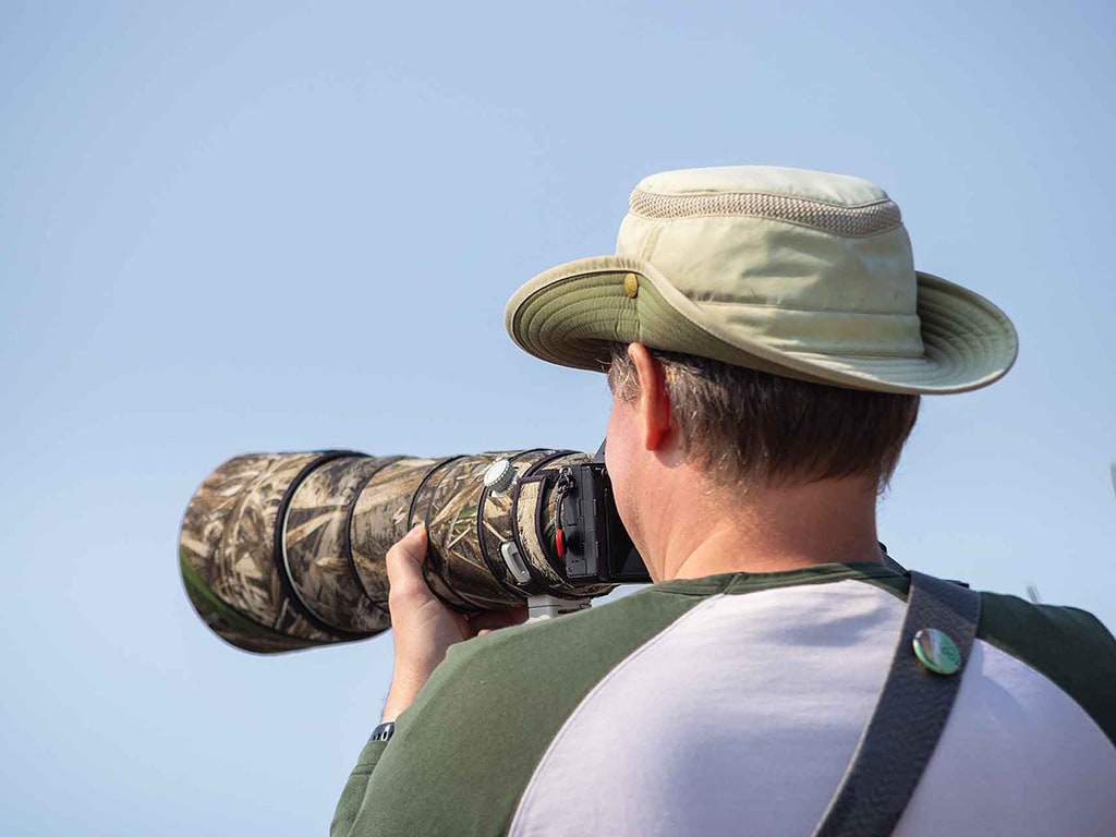 Rear angle view of a photographer with a camera