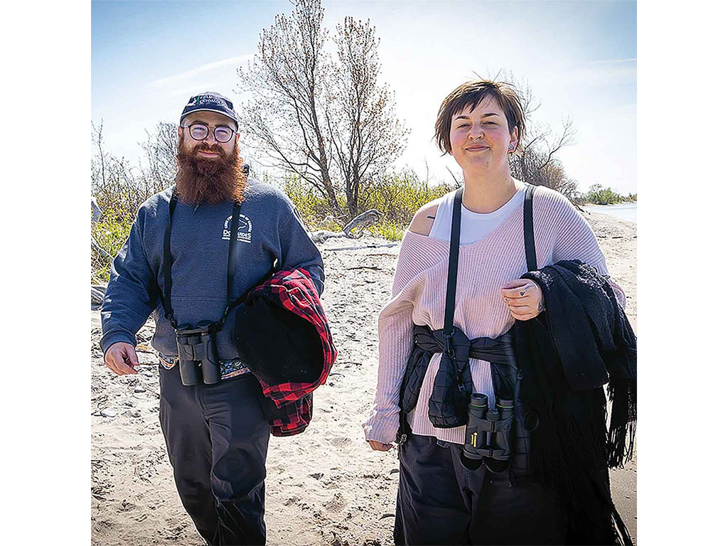 two people walking on a beach