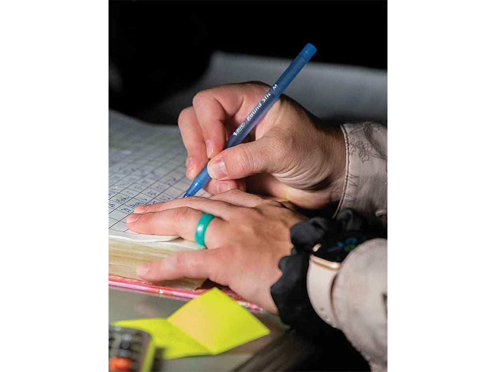 closeup of hands writing notes