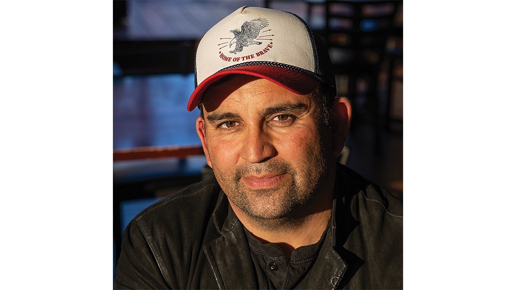closeup of grinning person in baseball cap
