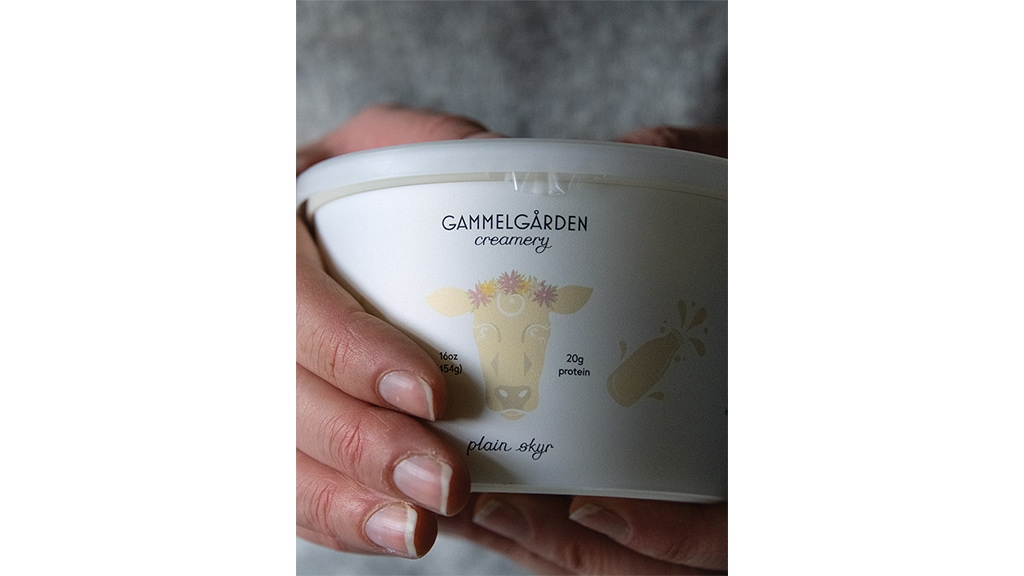 closeup of hands holding creamery box 