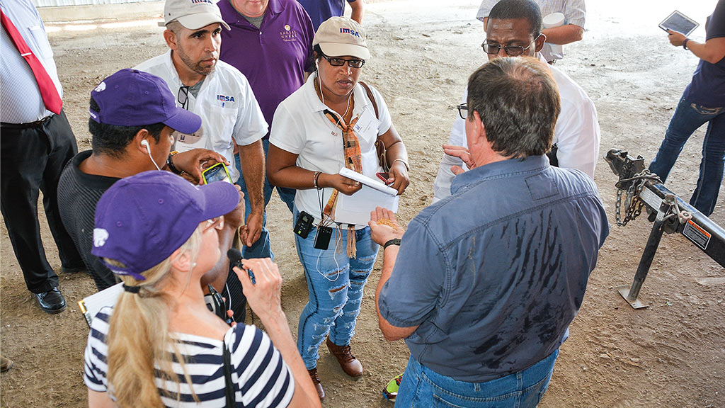 a group of people listening to a person speaking