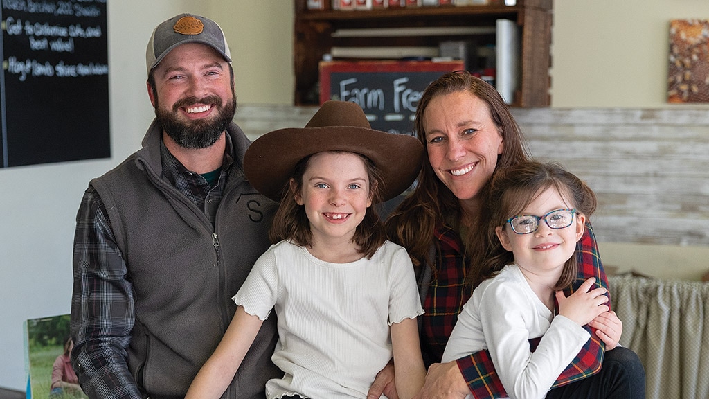 Family of four smiling for the photo shoot