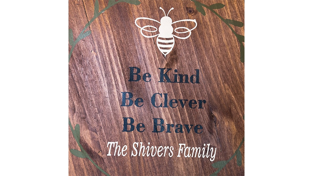 closeup of plank with outlined bee picture and text