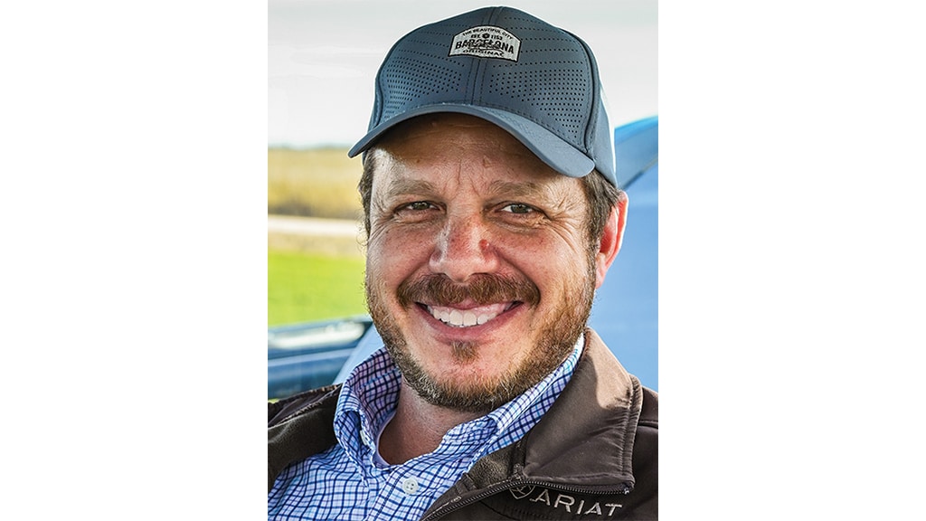 Kent Martin smiling wearing a baseball cap