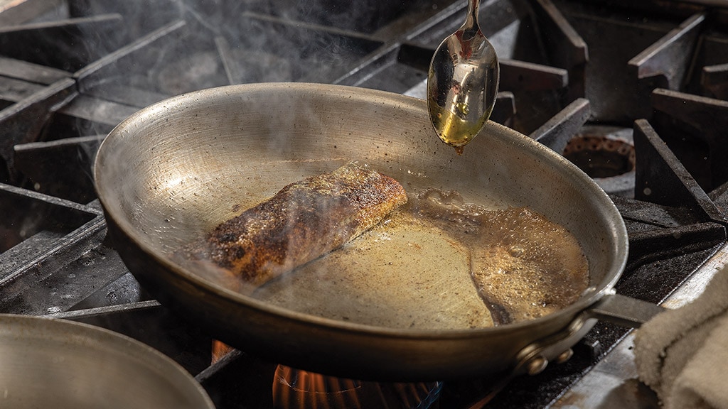 meat being fried in the frying pan