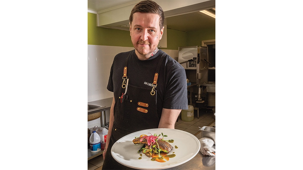 man showcasing this cusine in a plate for photoshoot
