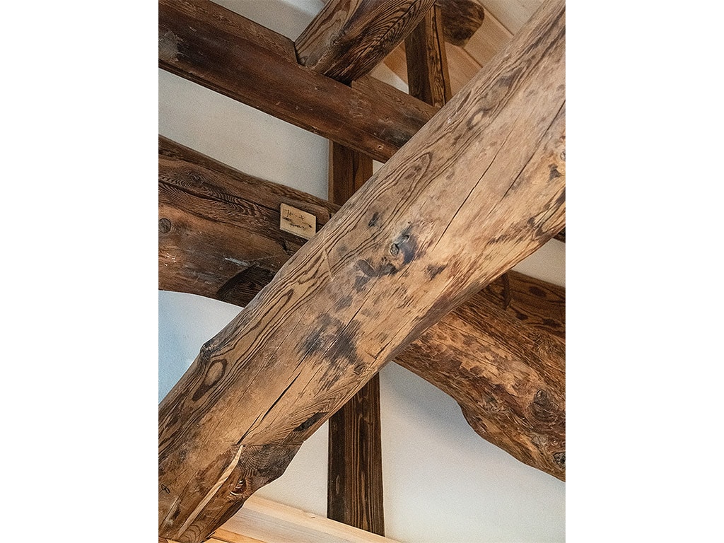 Rustic wooden rafters crossing in all different directions