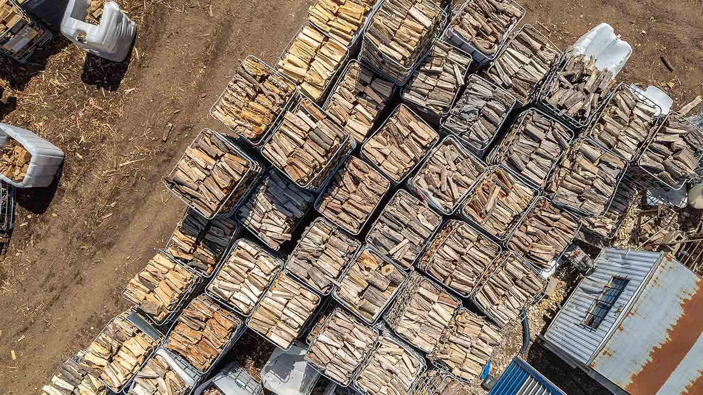 An overhead view of firewood stacked in big containers.