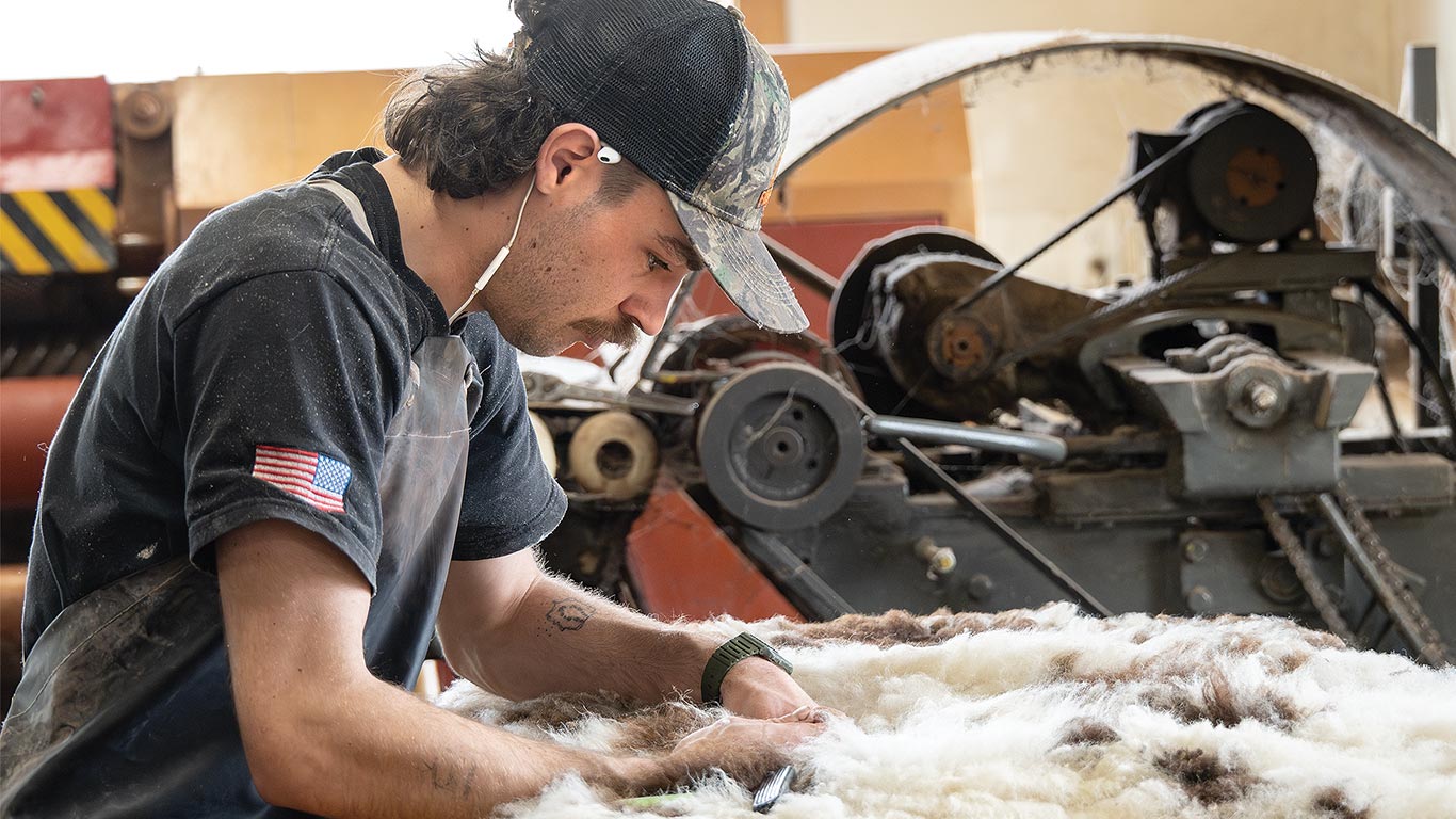 A worker finishing a sheepskin.