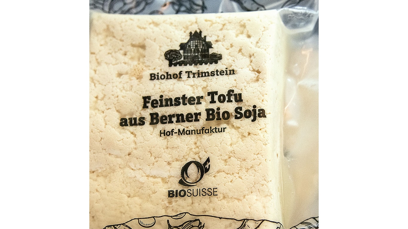 Package of fine tofu made from organic Bernese soy, featuring the Biohof Trimstein logo.
