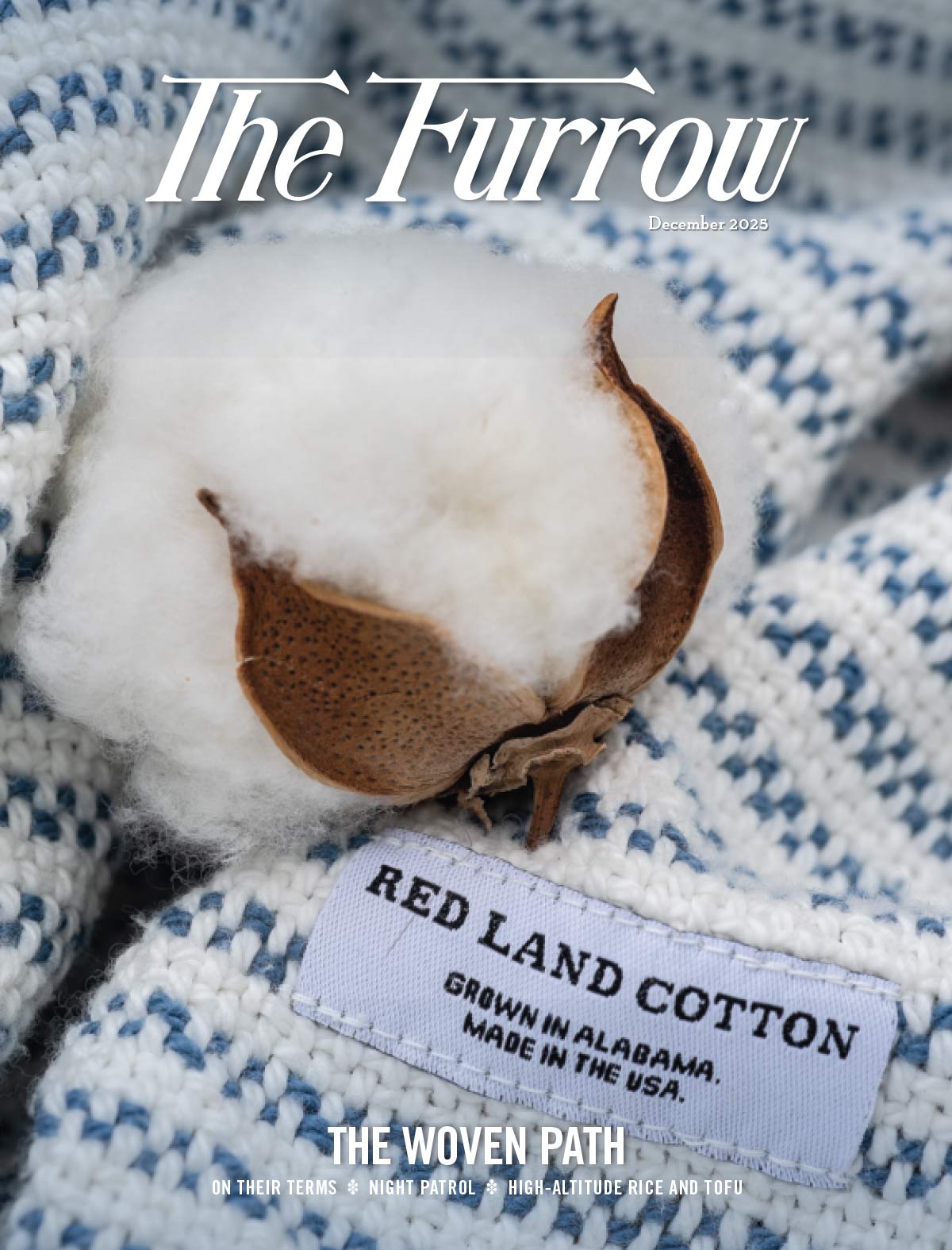 Cotton boll on blue-and-white woven fabric with tag reading "Red Land Cotton, Made in USA.", cover of The Furrow magazine.
