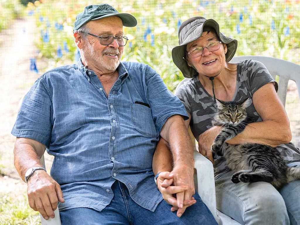 A couple sitting in porch beside garden