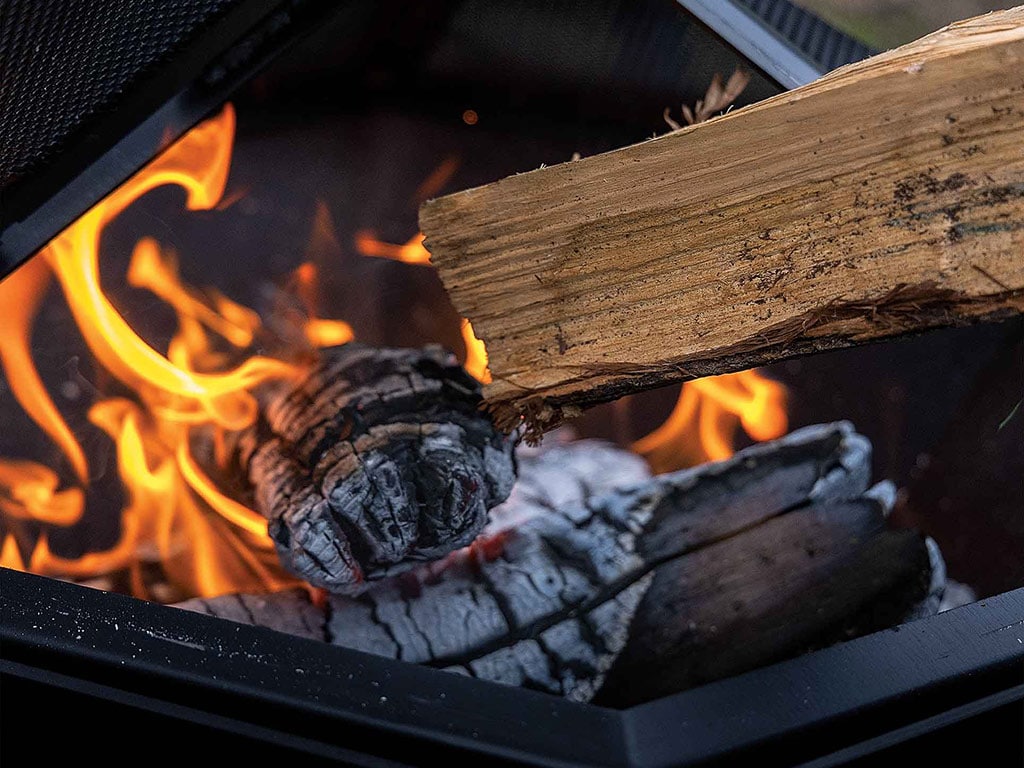 Close-up of a burning log in a fire pit