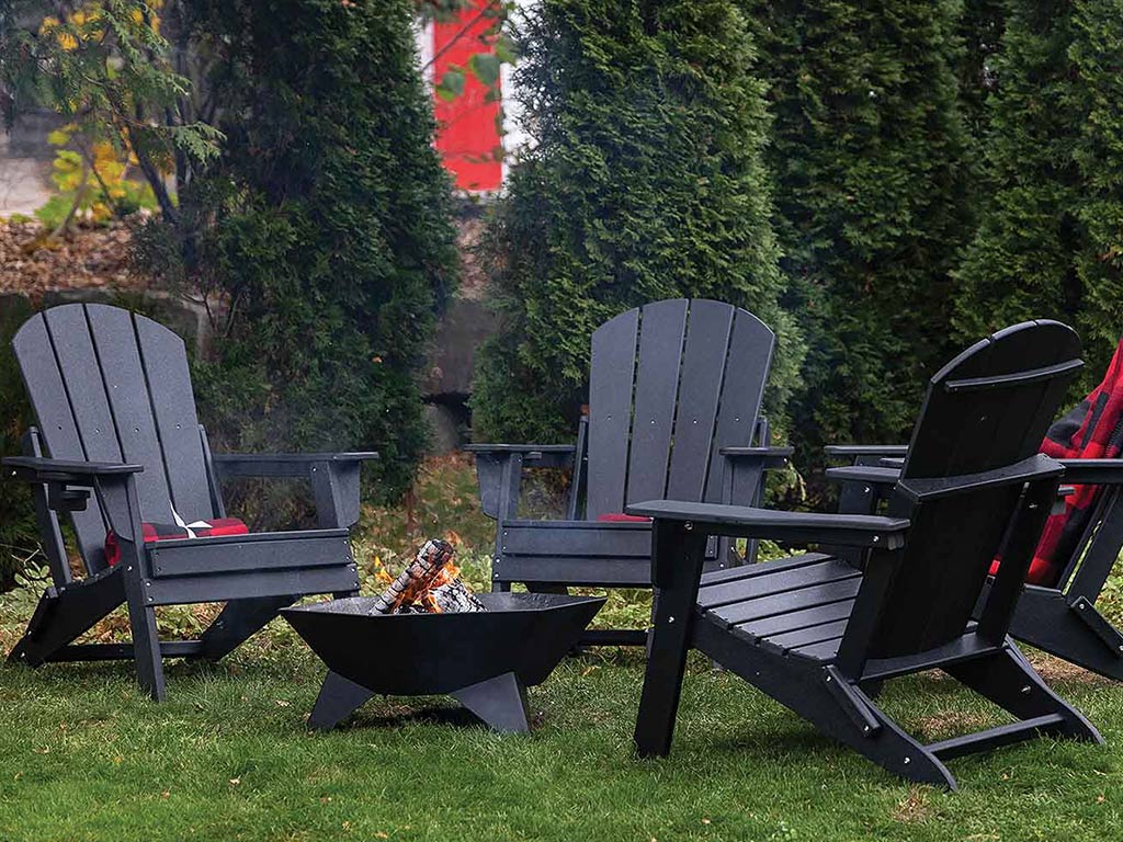 Three outdoor chairs circling around fire pit