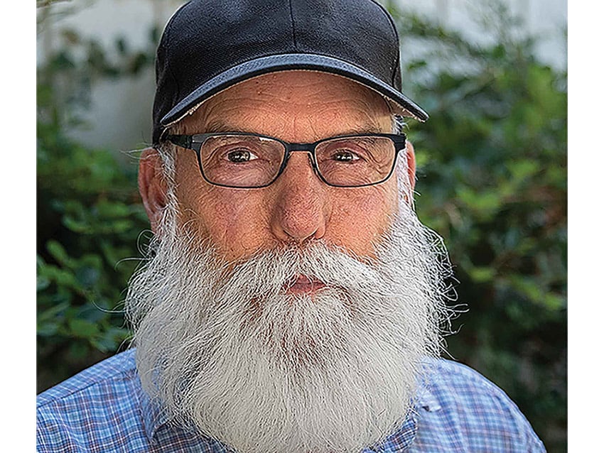 A portrait of a person with grey long beard