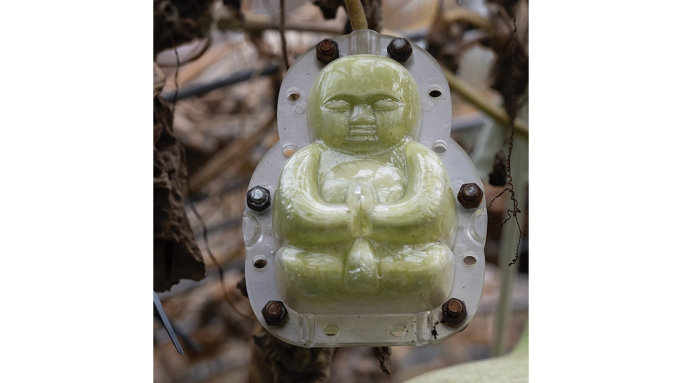 Green gourd figure cast in a clear plastic mold.
