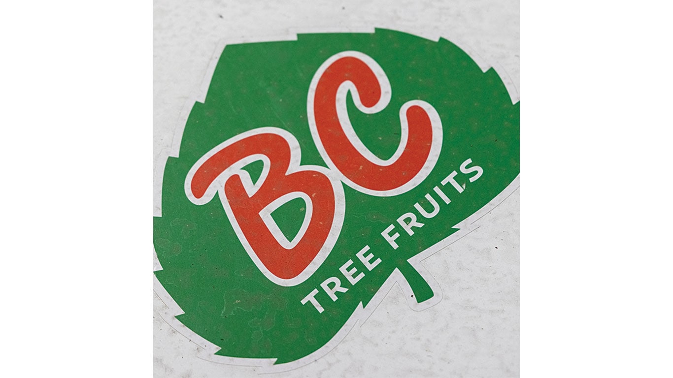 BC Tree Fruits logo on a green, leaf-shaped sign.