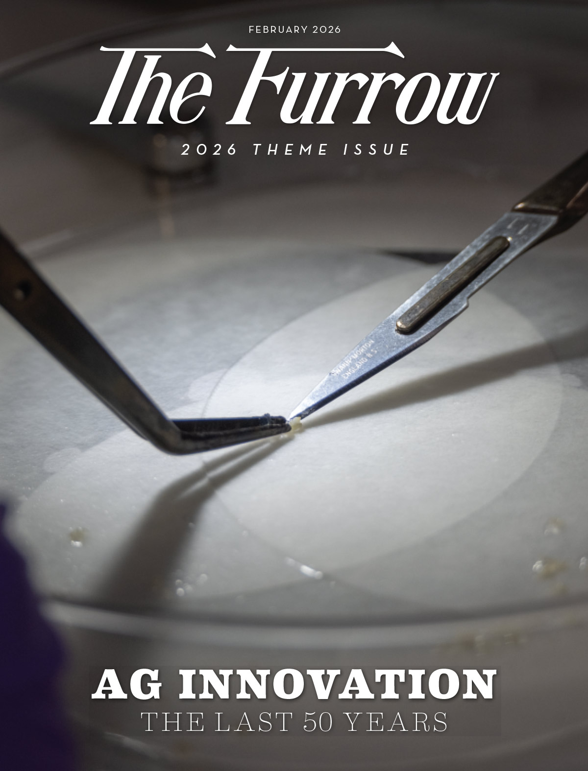 Two precision tools holding a tiny sample inside a petri dish on a Furrow magazine cover.
