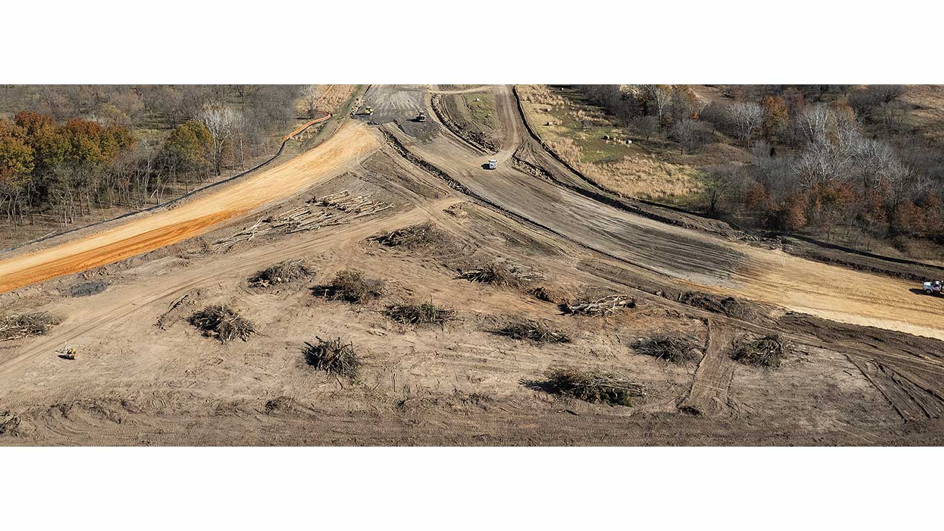 A large field of dirt for construction with a few pathways