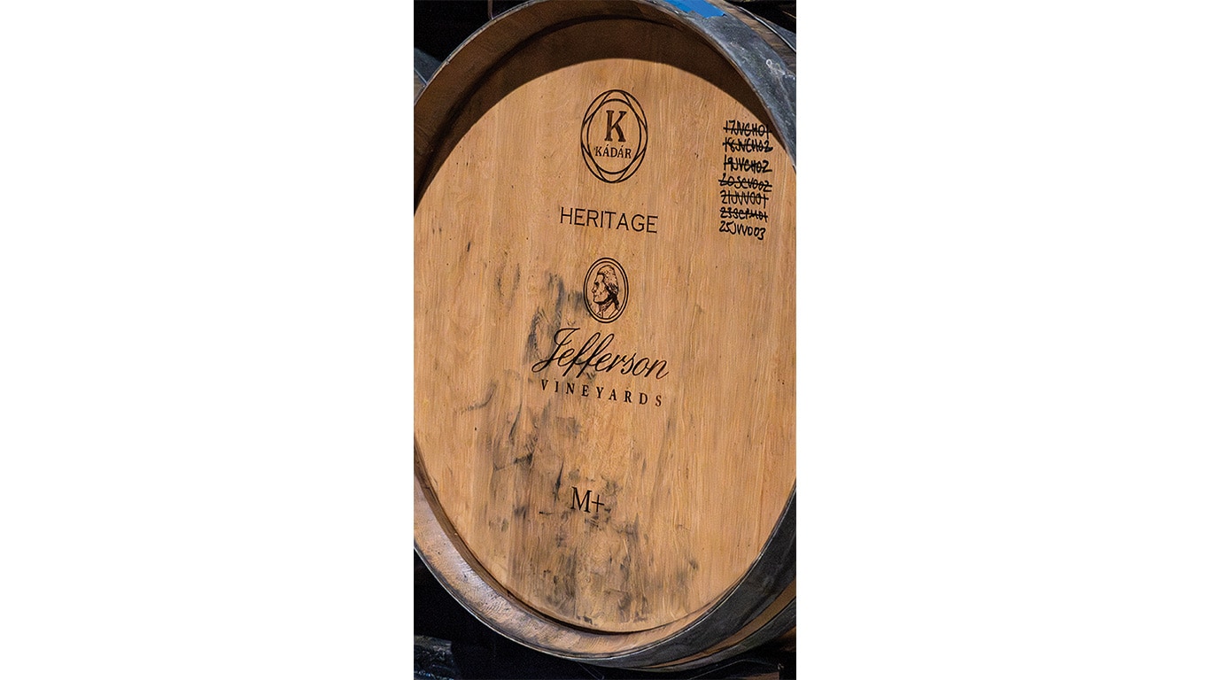 Close-up of a wooden wine barrel labeled "Jefferson Vineyards" with markings on the side.