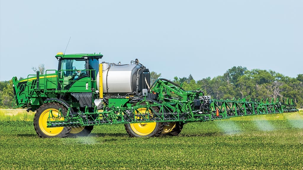 Cab tractor in a field using See & Spray Premium